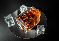 Close-up shot of an elegant cognac bottle with warm gold accents reflecting softly on a dark surface