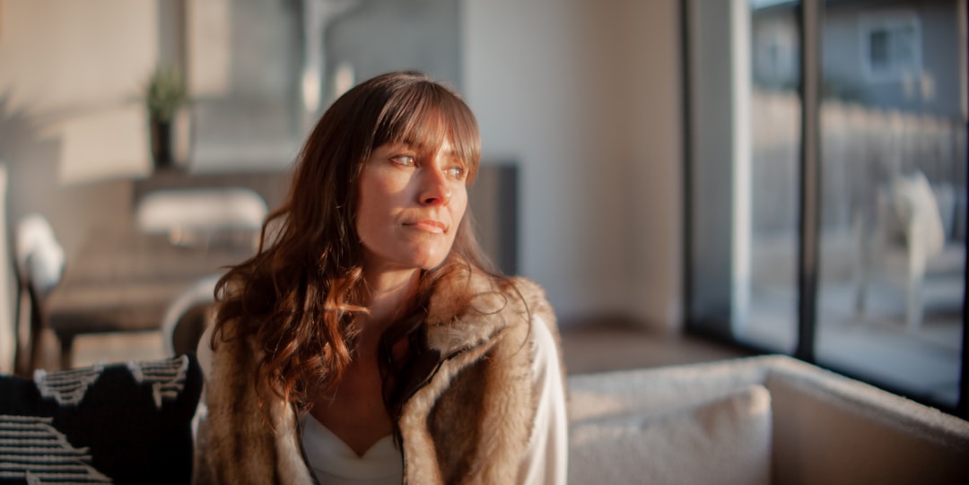 a woman sitting on a couch in a living room