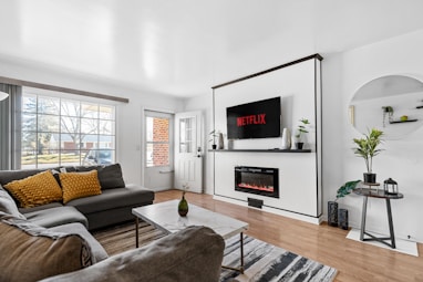 a living room filled with furniture and a flat screen tv