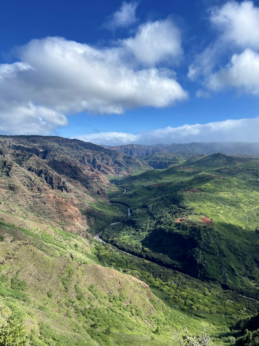 a view of a valley with a river running through it