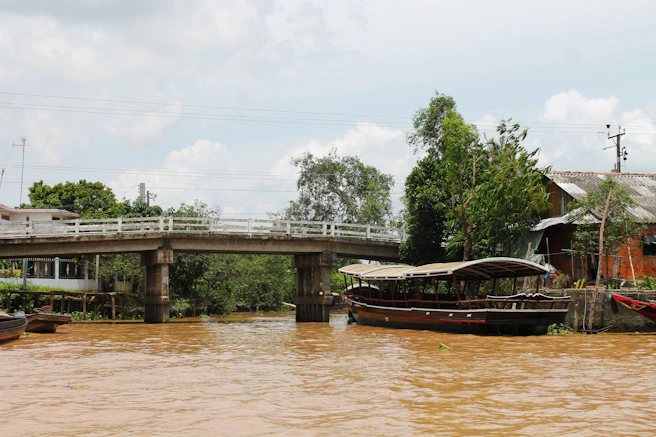 a bridge over a river with boats on it