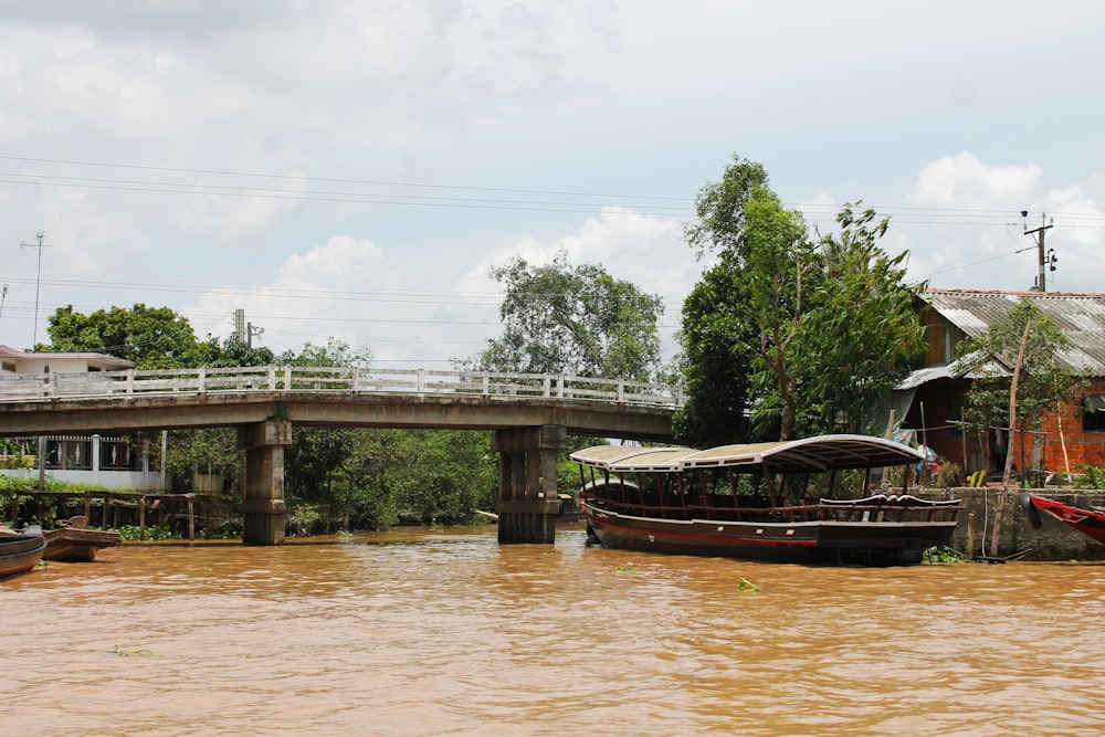 a bridge over a river with boats on it