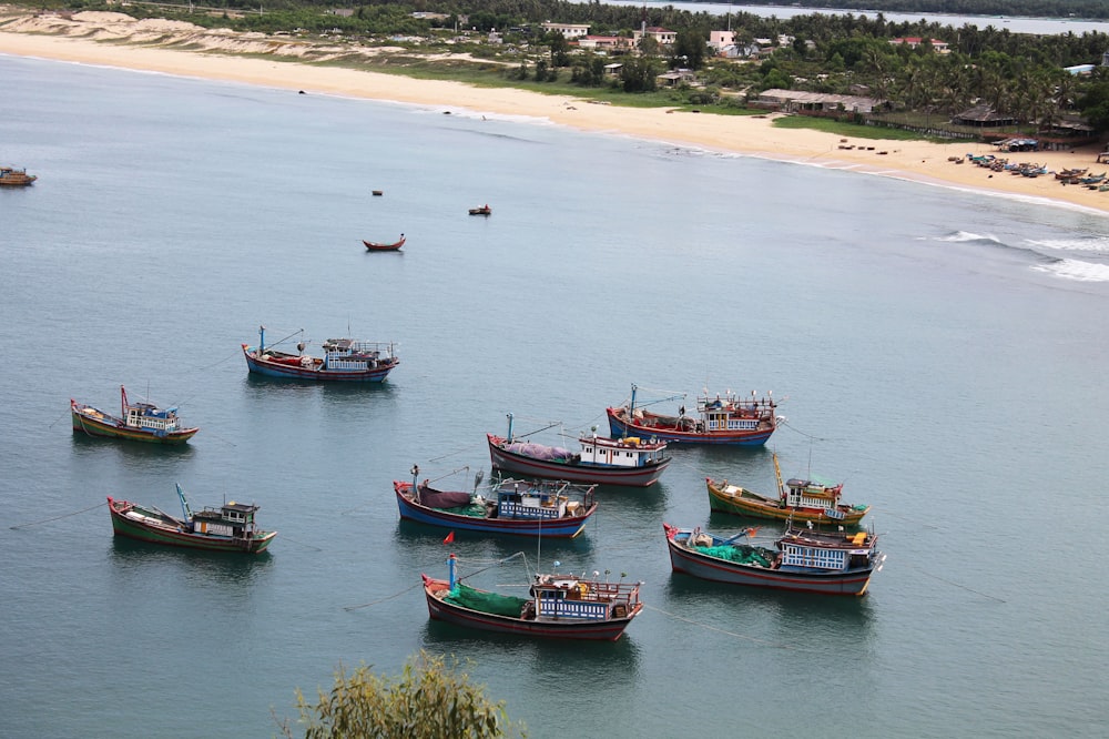 a group of boats floating on top of a body of water