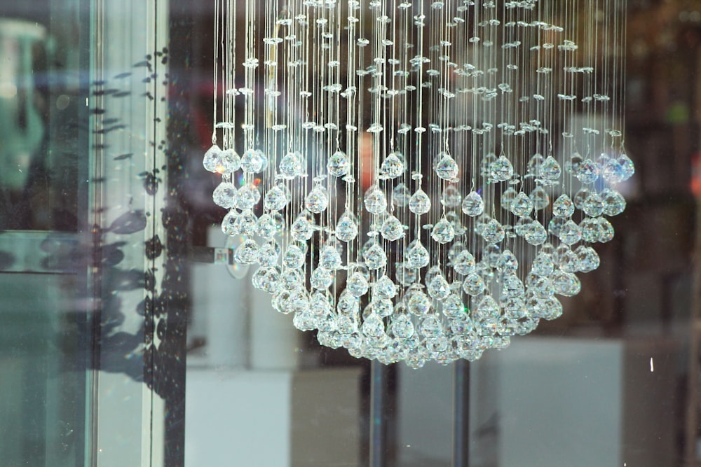 a chandelier hanging from a glass window