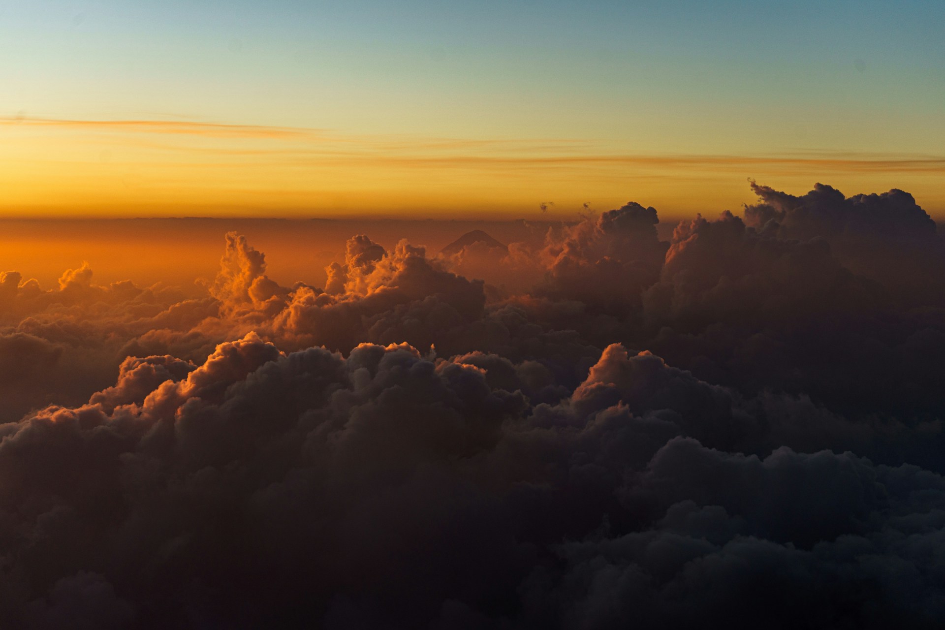 the sun is setting over the clouds in the sky