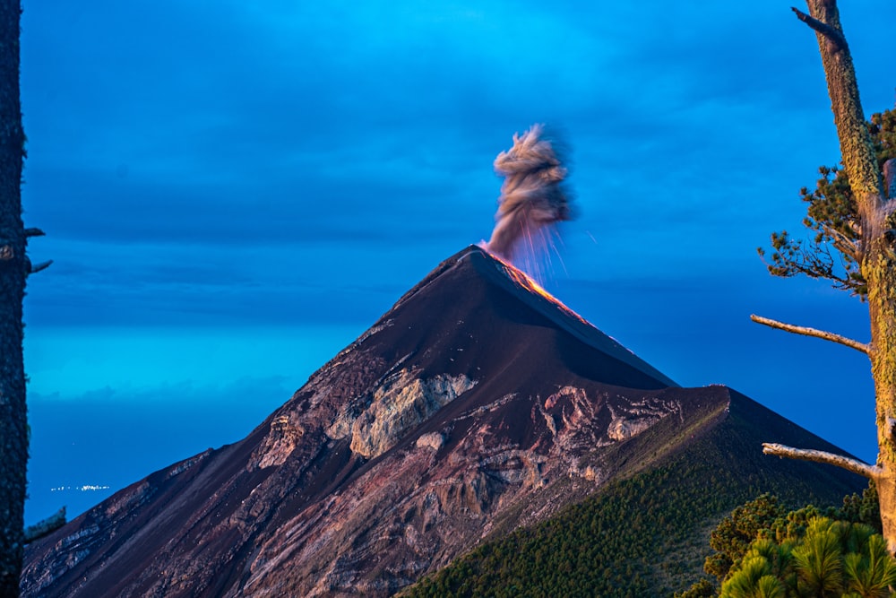 a woman is standing on top of a mountain