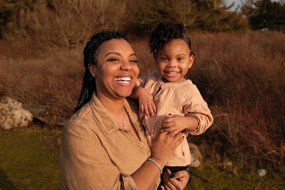 a woman holding a small child in her arms