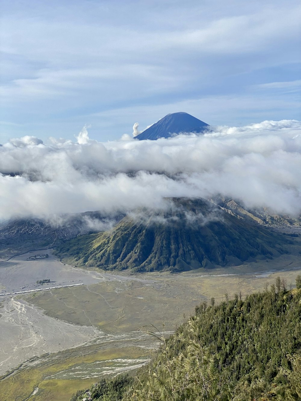 a view of a mountain with a cloud covering it