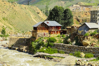 Spacious rustic home with wooden deck overlooking river landscape.