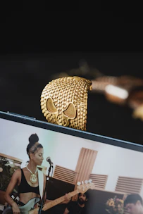 A smiling woman viewing a live video demo of a necklace on her smartphone.