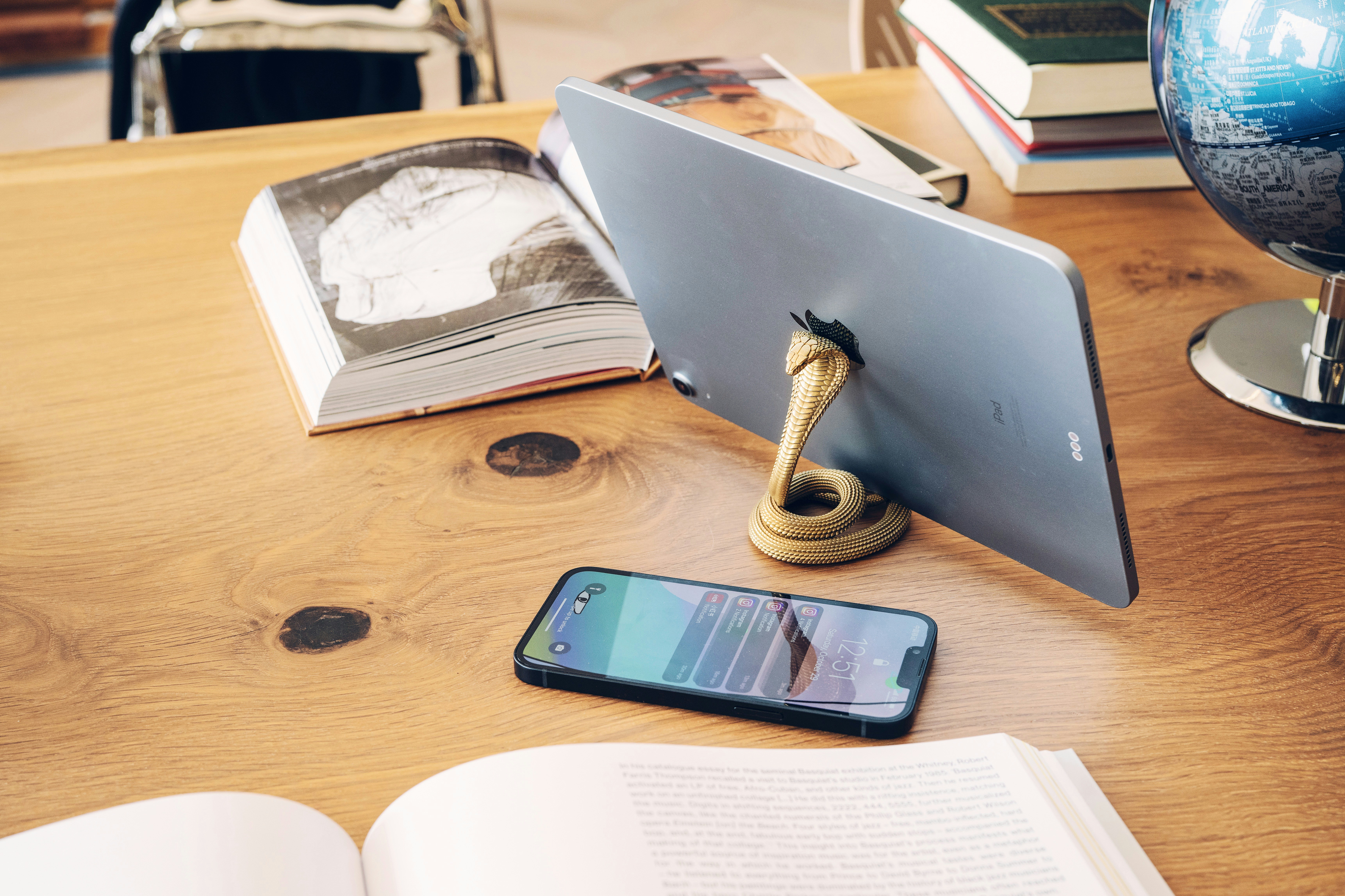 an open book and a cell phone on a table