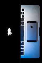 an image of an iphone next to a laptop