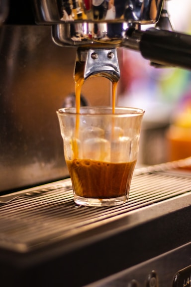 a cup of coffee being filled with liquid