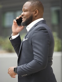 a man in a suit talking on a cell phone