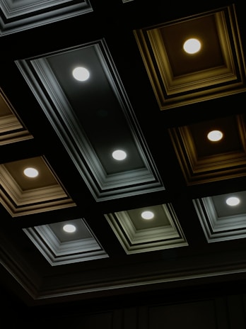 Interior shot showing a ceiling with installed panels and lighting.