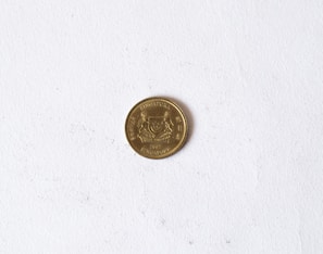 A coin with 'Singapore' and the year 2007 inscribed on it is placed on a plain, white background. The coin features a crest and some text around the edge.