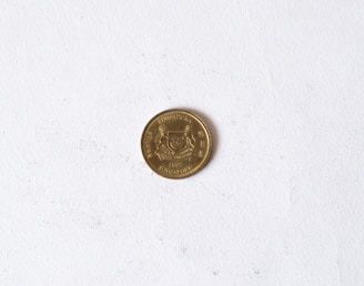 A coin with 'Singapore' and the year 2007 inscribed on it is placed on a plain, white background. The coin features a crest and some text around the edge.