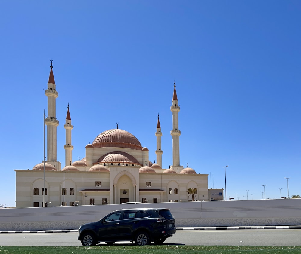 a car is parked in front of a large building