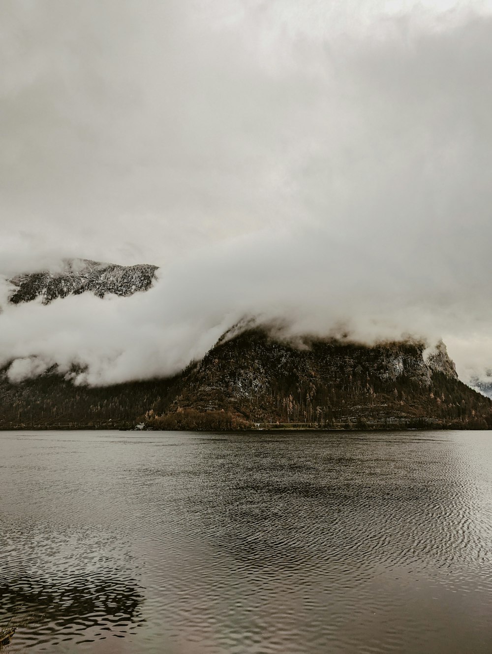 a large body of water with a mountain in the background