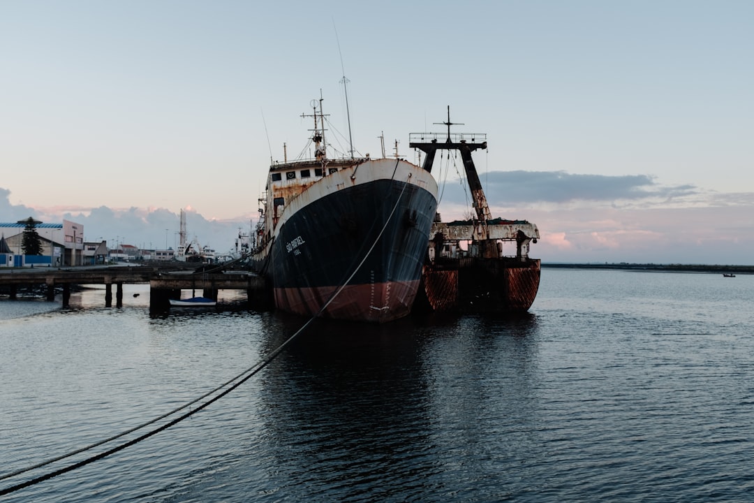 a large boat docked at a pier in the water,
