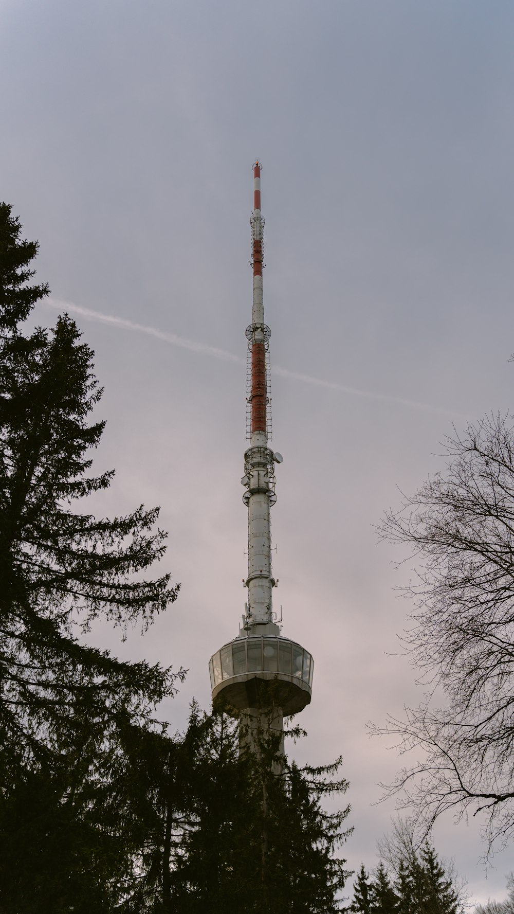 a tall tower with a red and white top