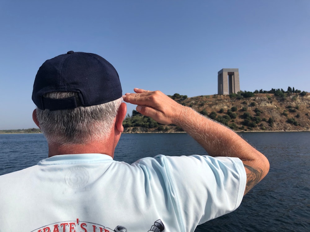 a man standing on a boat looking at the water