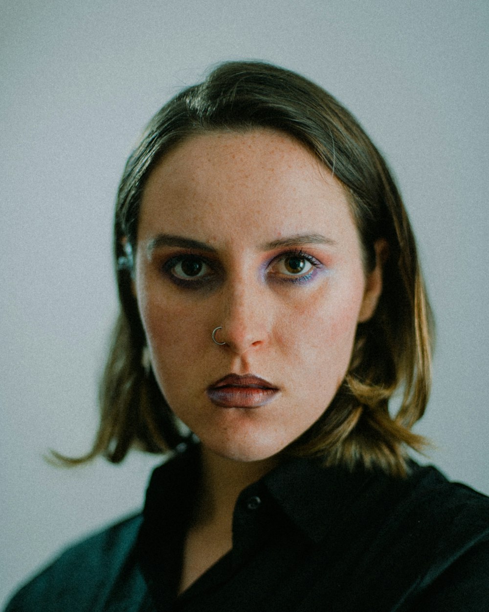 a woman with a piercing on her nose