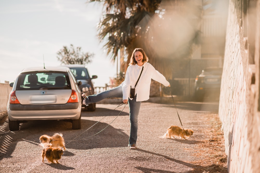 a woman walking two dogs on a leash