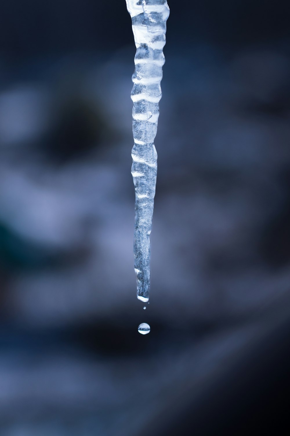 a long icicle hanging from the side of a building