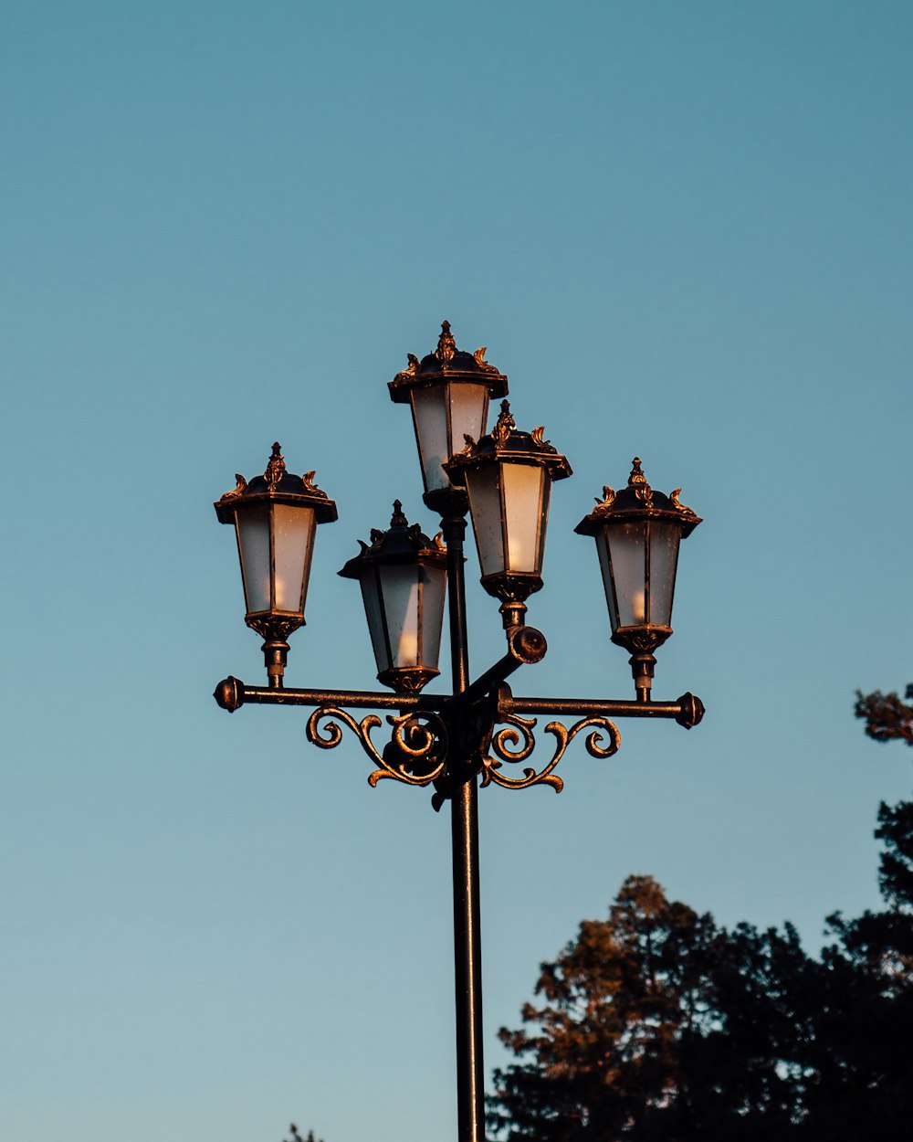 a lamp post with four lights on top of it