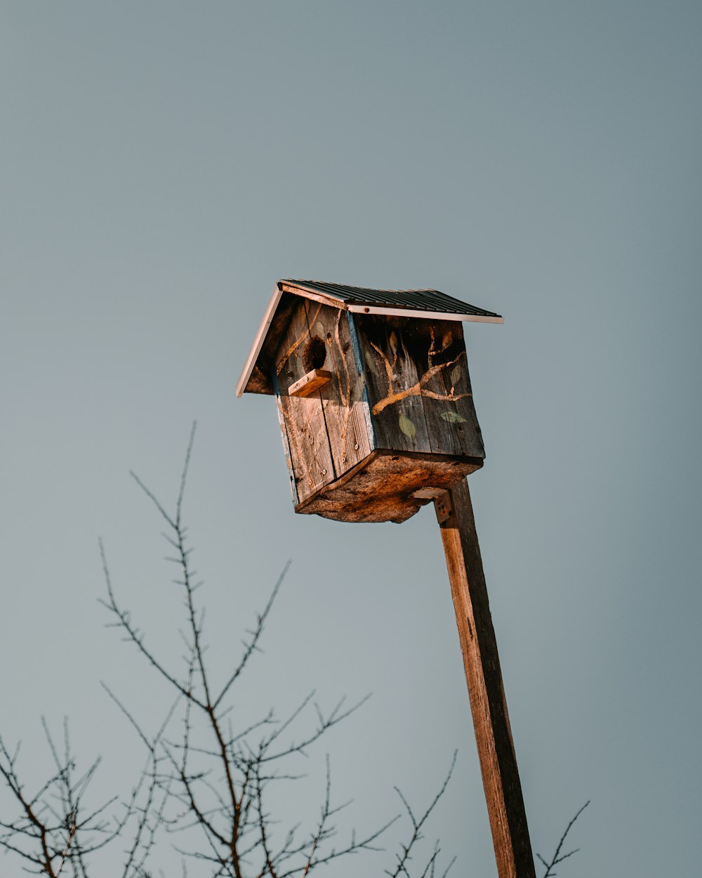 a bird house on top of a wooden pole