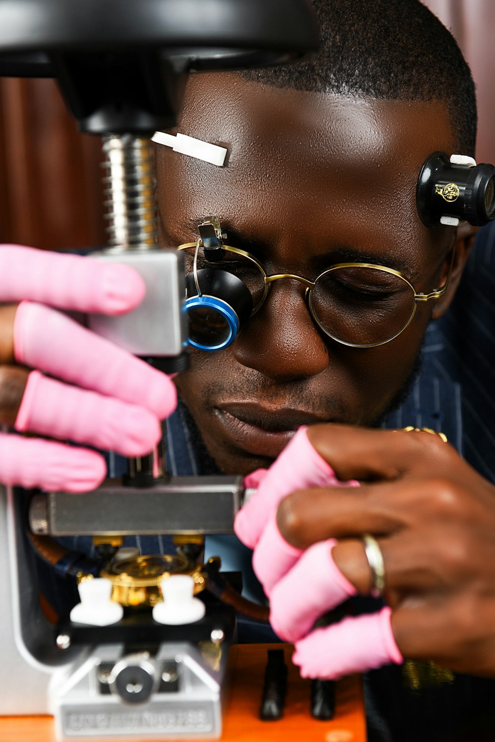 a man looking through a microscope at something