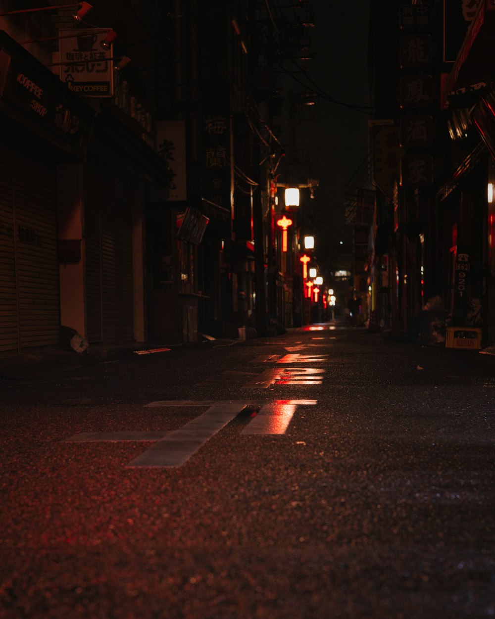 a dark city street at night with a red light