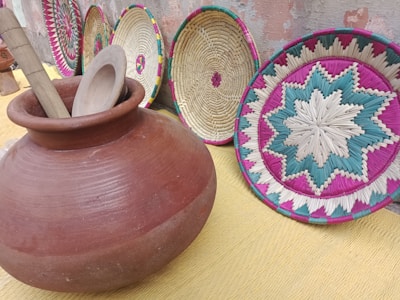 Close-up of vibrant rattan baskets and colorful pottery typical of bohemian decor styles.