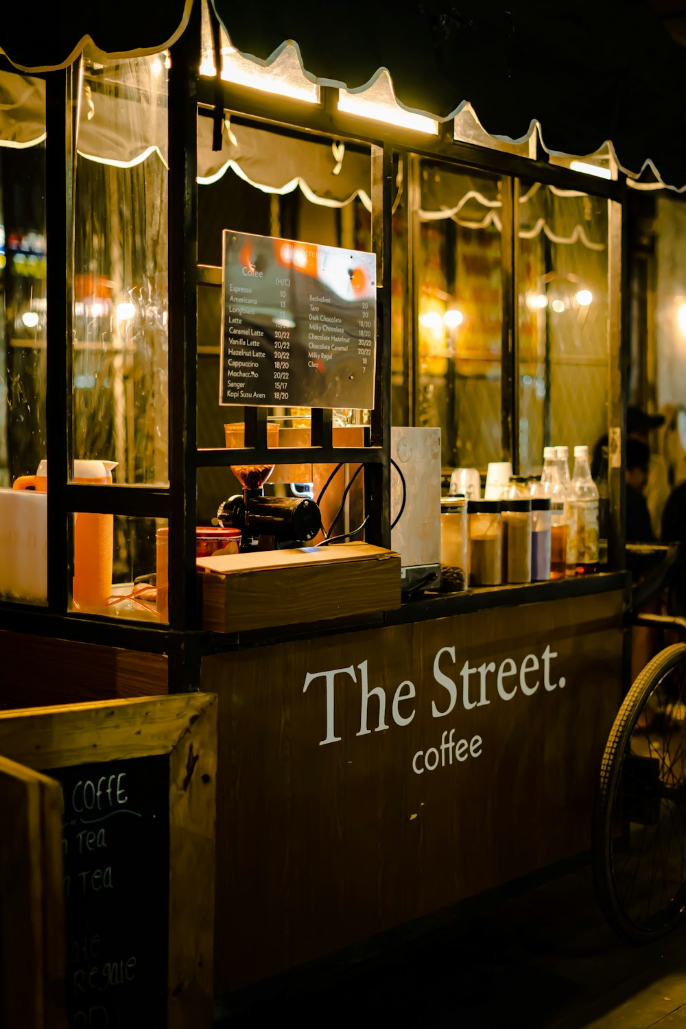 a food cart with a sign that says the street coffee