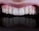 Close-up of a smiling person showing healthy teeth in a dental clinic.