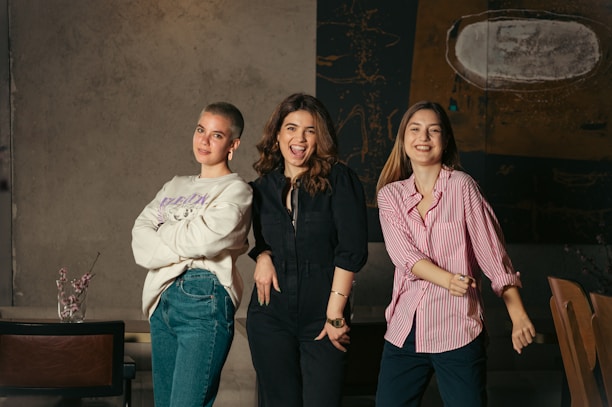 a group of three women standing next to each other