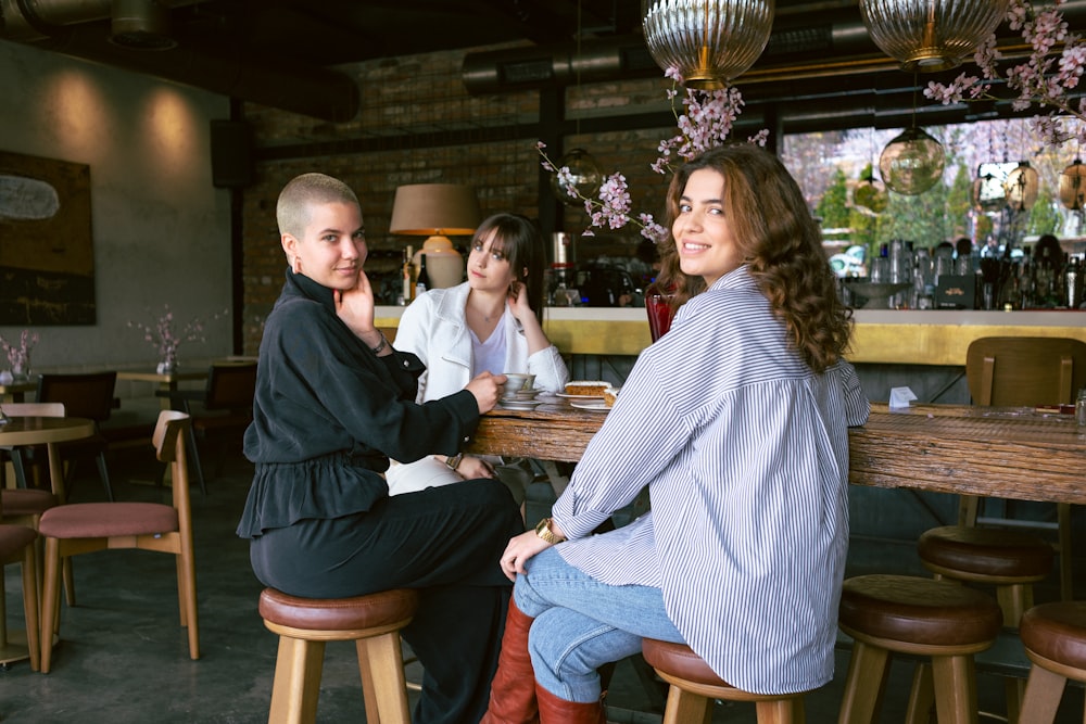 a group of people sitting at a table in a restaurant