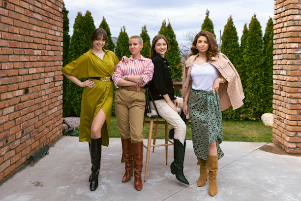 A diverse group of confident women in Air Force uniforms sharing a moment of camaraderie outdoors.