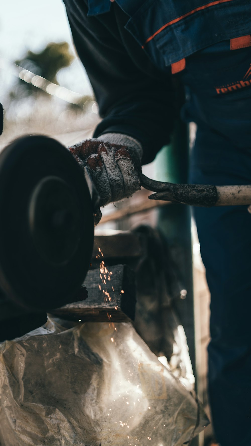 a person grinding metal with a grinder