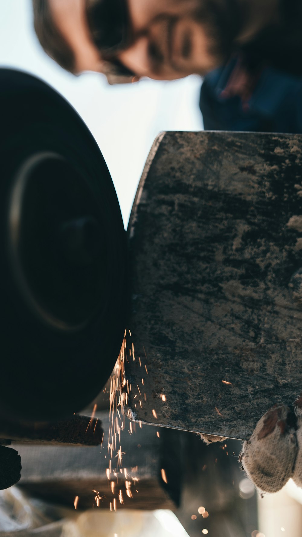 a man working on a piece of metal with a grinder