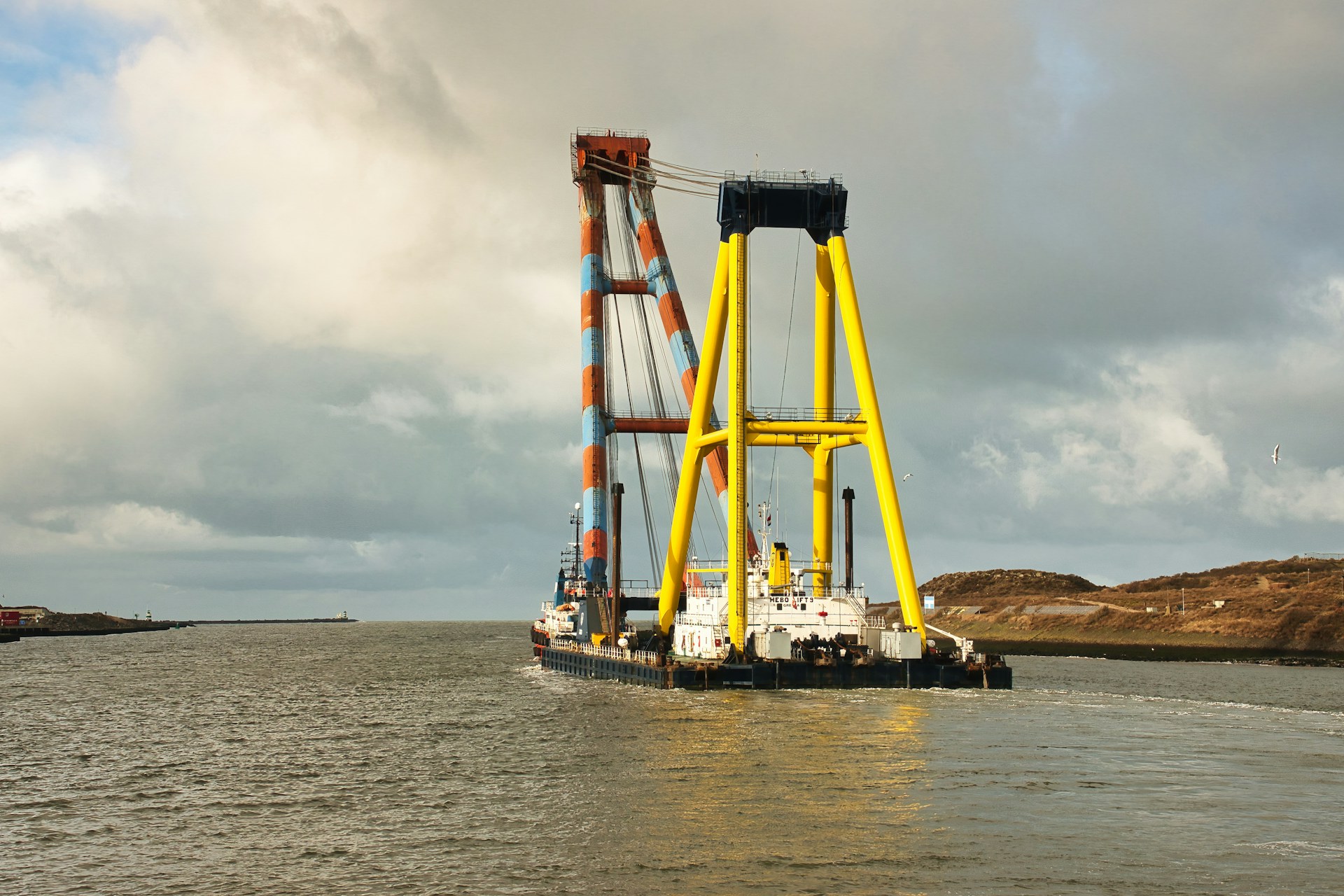 Aerial shot of a maritime service vessel operated by Saudi Drill navigating through calm coastal waters.