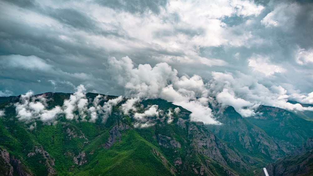 a view of a mountain range with clouds in the sky