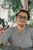 a woman wearing glasses and a black and white checkered shirt