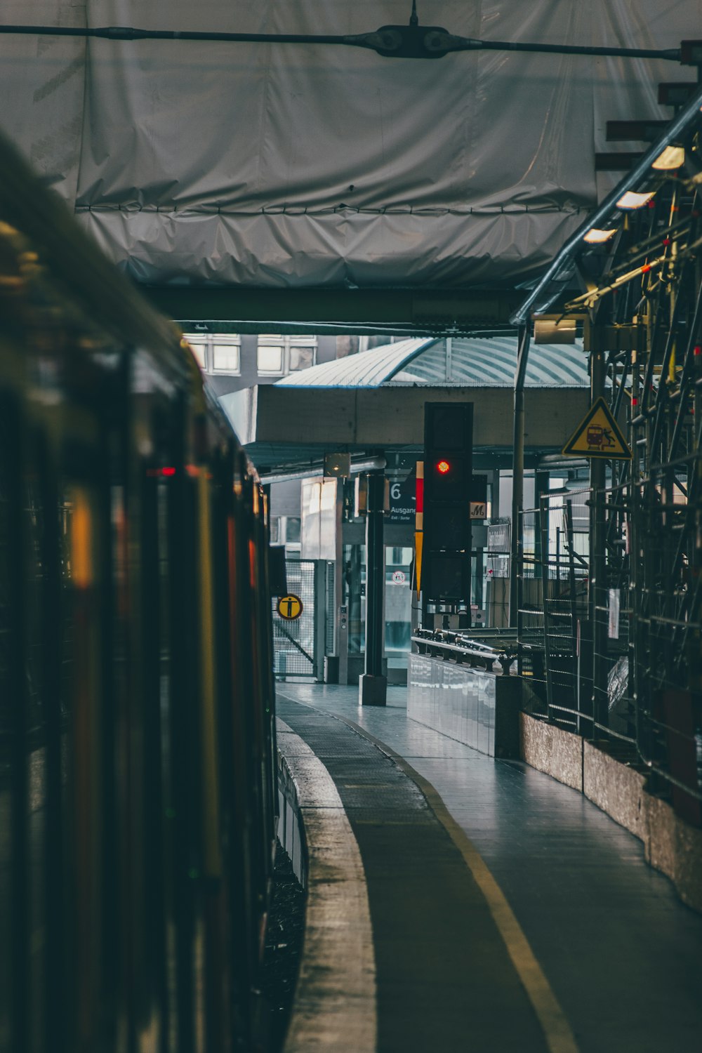 a train pulling into a train station next to a platform