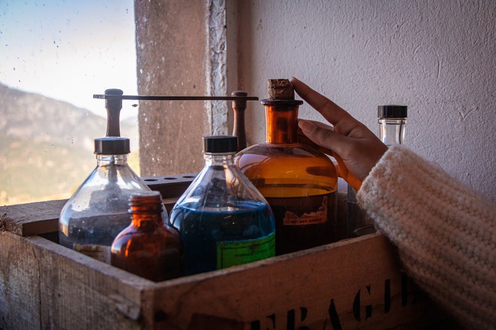 a wooden box filled with bottles of liquid