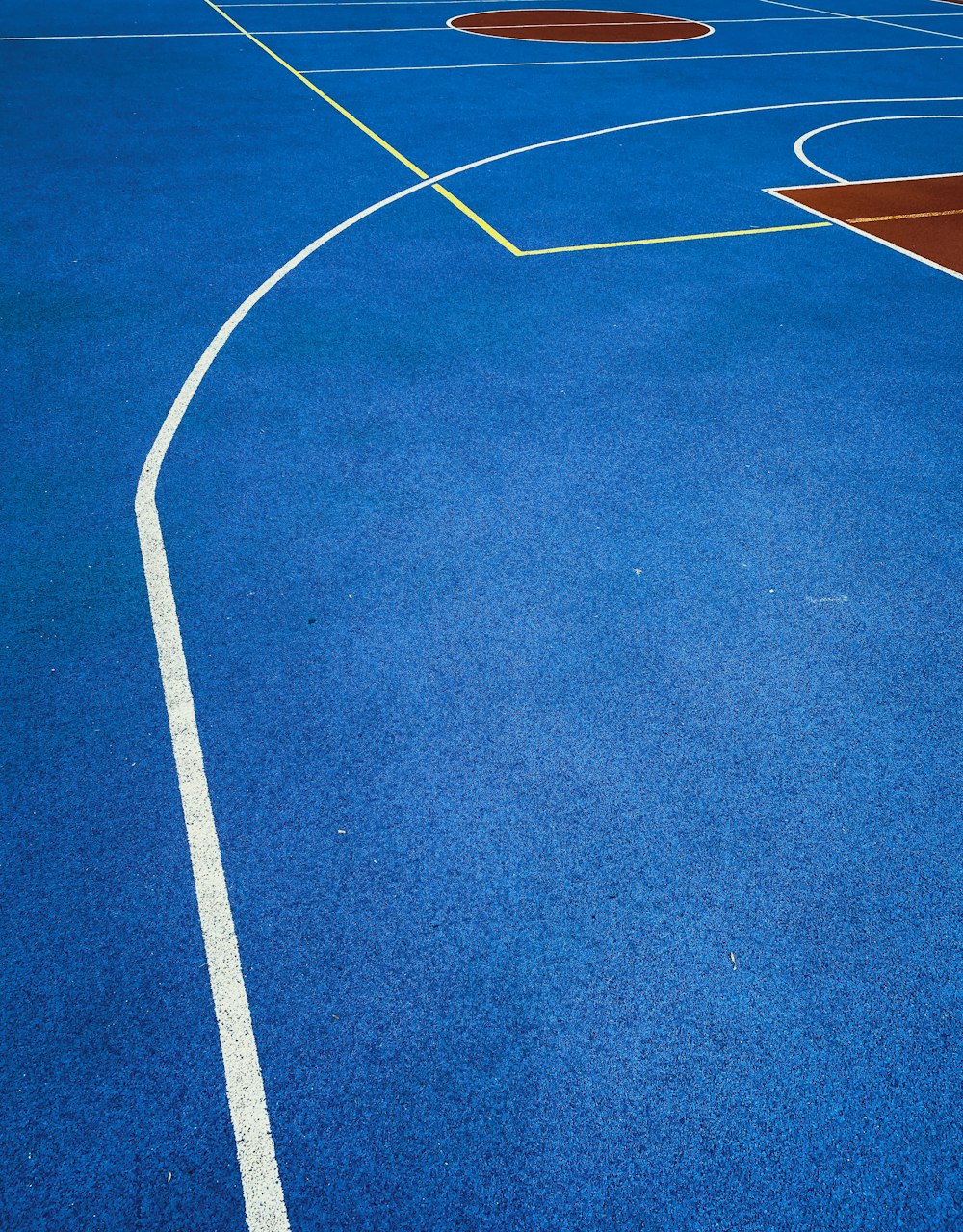 a blue basketball court with white lines on it