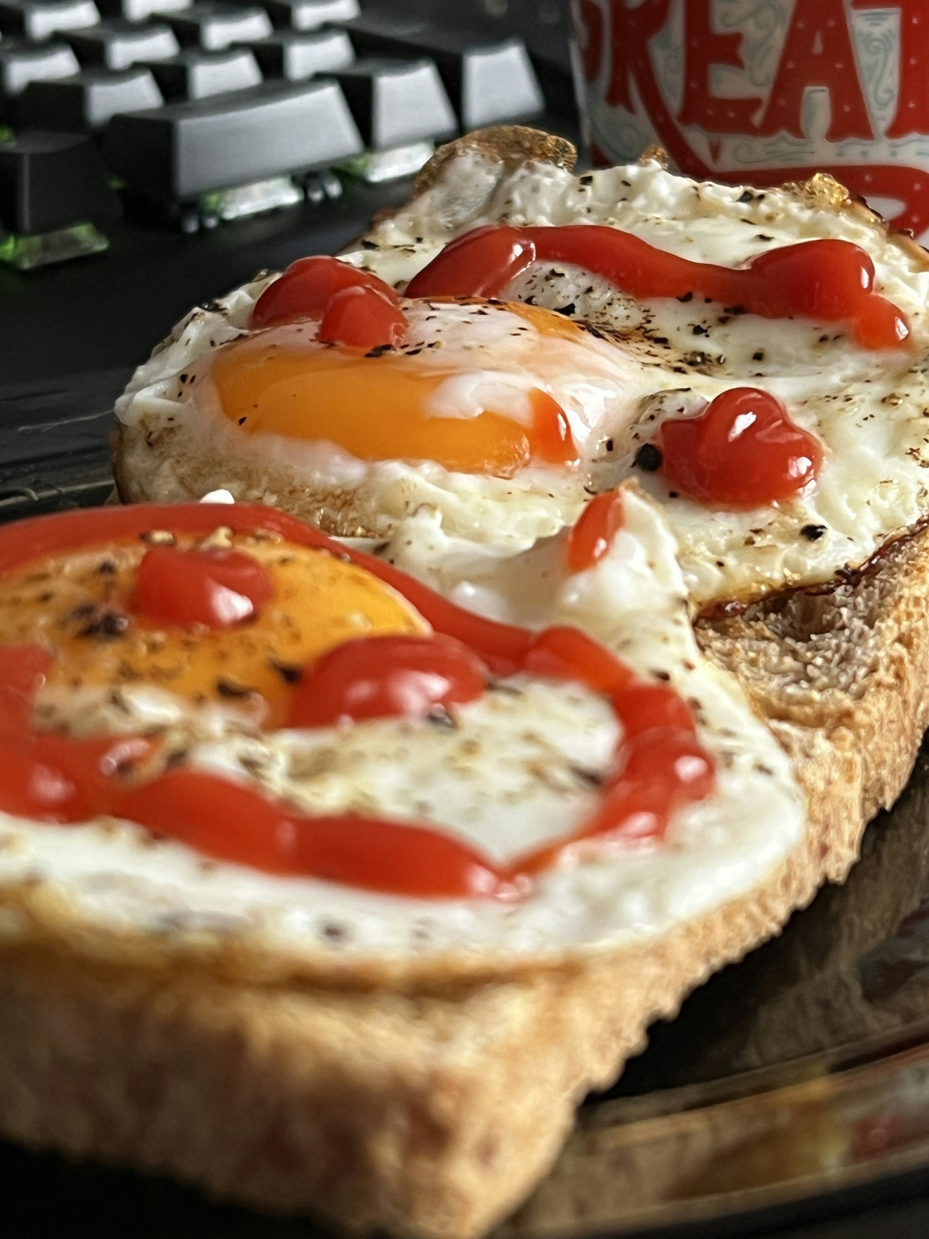 Crispy chips with fried egg on a paper plate with ketchup on the side