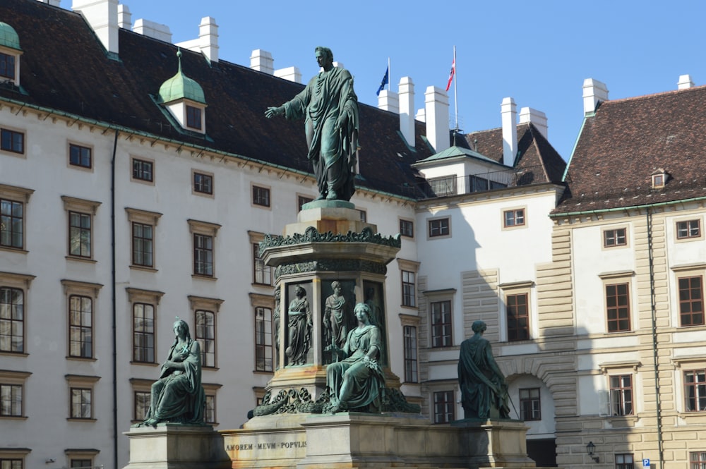 a statue in front of a building with many windows