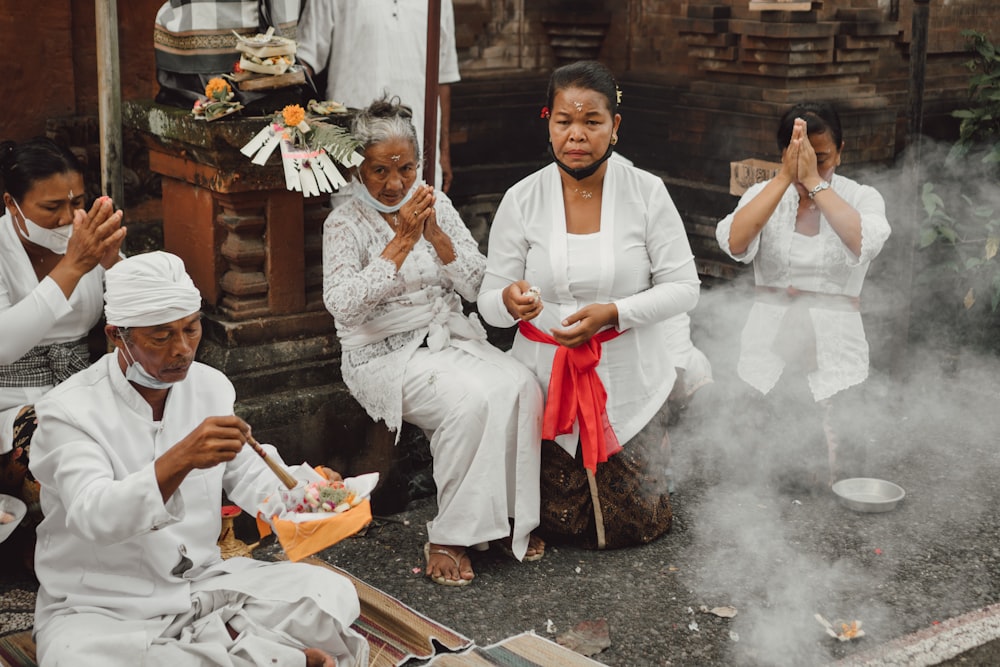 a group of people sitting around a fire pit